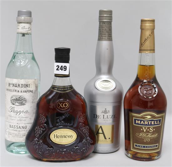 A bottle of Hennessy XO, two cognacs and one grappa